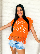 Load image into Gallery viewer, A woman wearing Queen of Sparkles orange fringe sweater vest with 'go vols' text on the front, paired with denim shorts.
